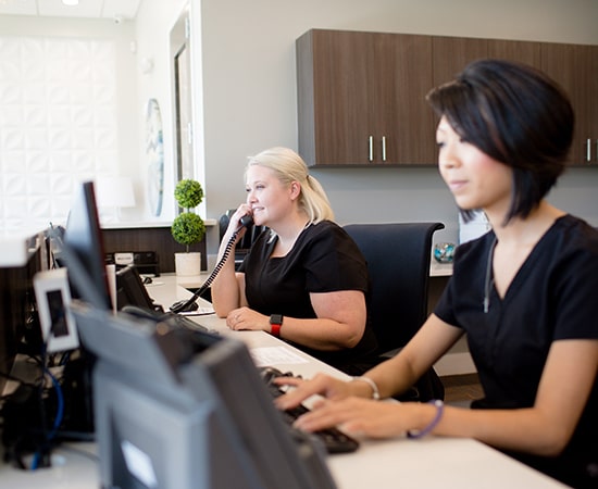 Night and Day Dental employee answering the phone for dental emergency services